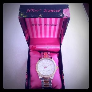 Betsey Johnson gold and silver tone watch.